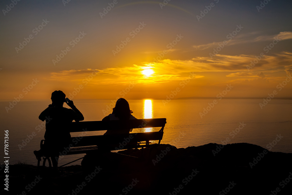 couple taking a shot of a sunset