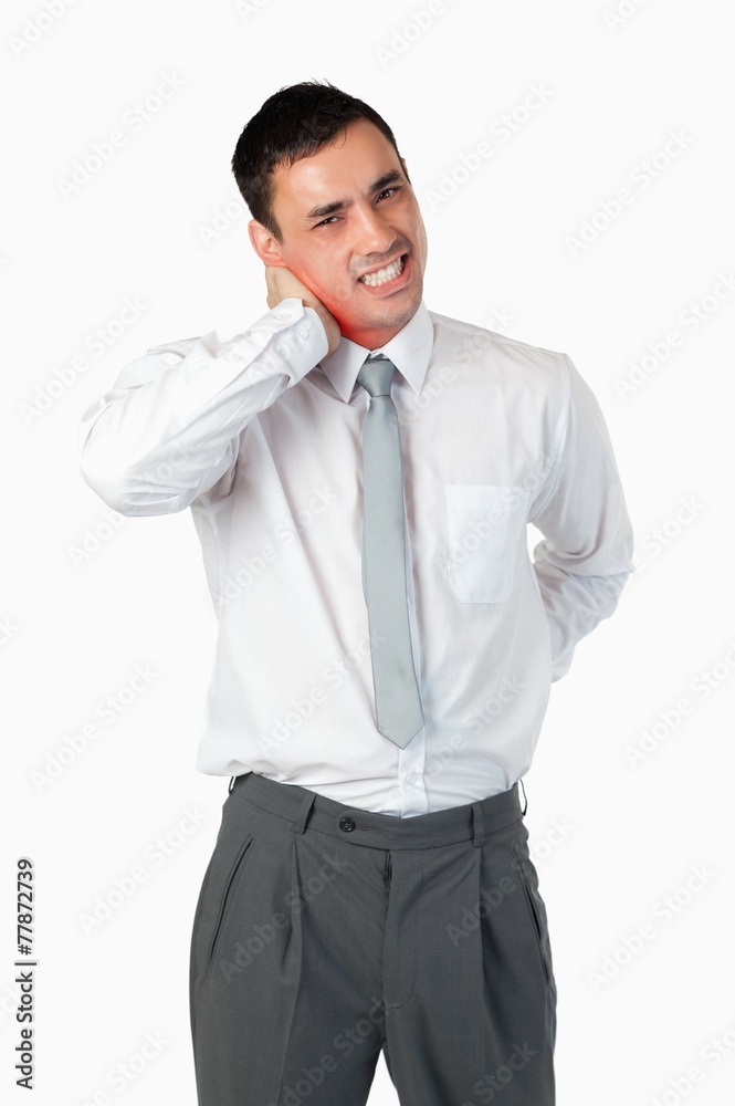 Portrait of a young businessman having a back pain Portrait of a young businessman having a back pain