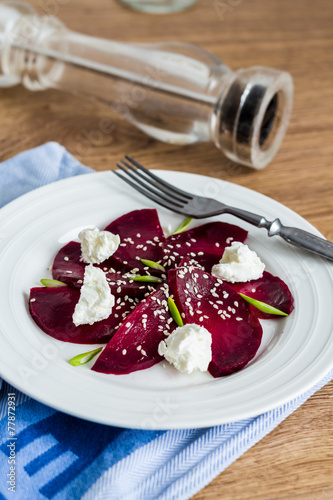 beet salad with goat cheese, garlic and sesame seeds