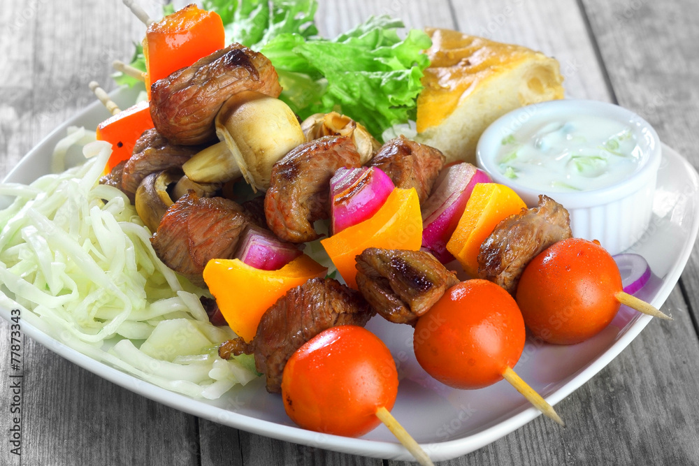 Kebabs on Plate with Mustard, Veggies and Bread Kebabs on Plate with Mustard, Veggies and Bread