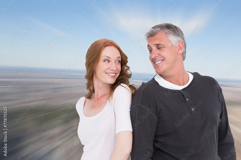 Obraz premium Composite image of casual couple smiling at each other