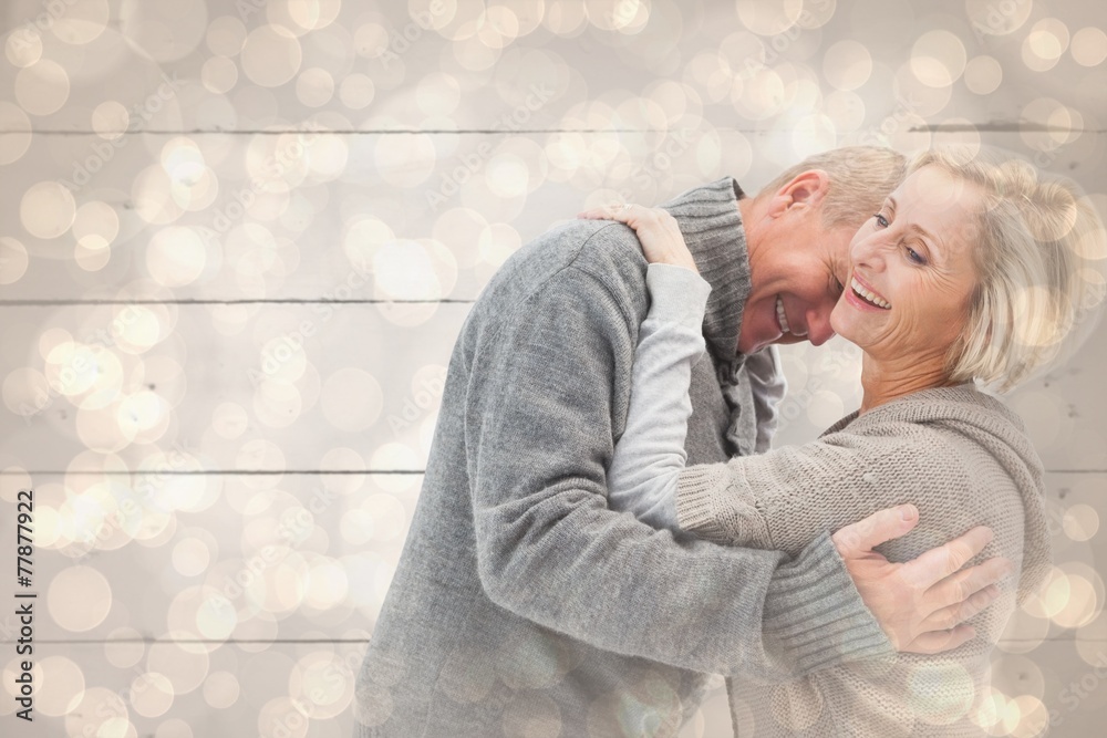 Composite image of happy mature couple in winter clothes Composite image of happy mature couple in winter clothes