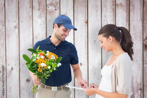 Composite image of happy flower delivery man with customer