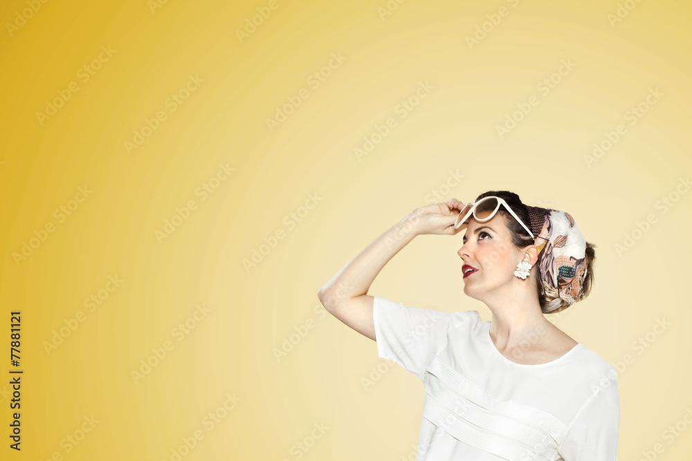 Woman with glasses looking foward yellow background.