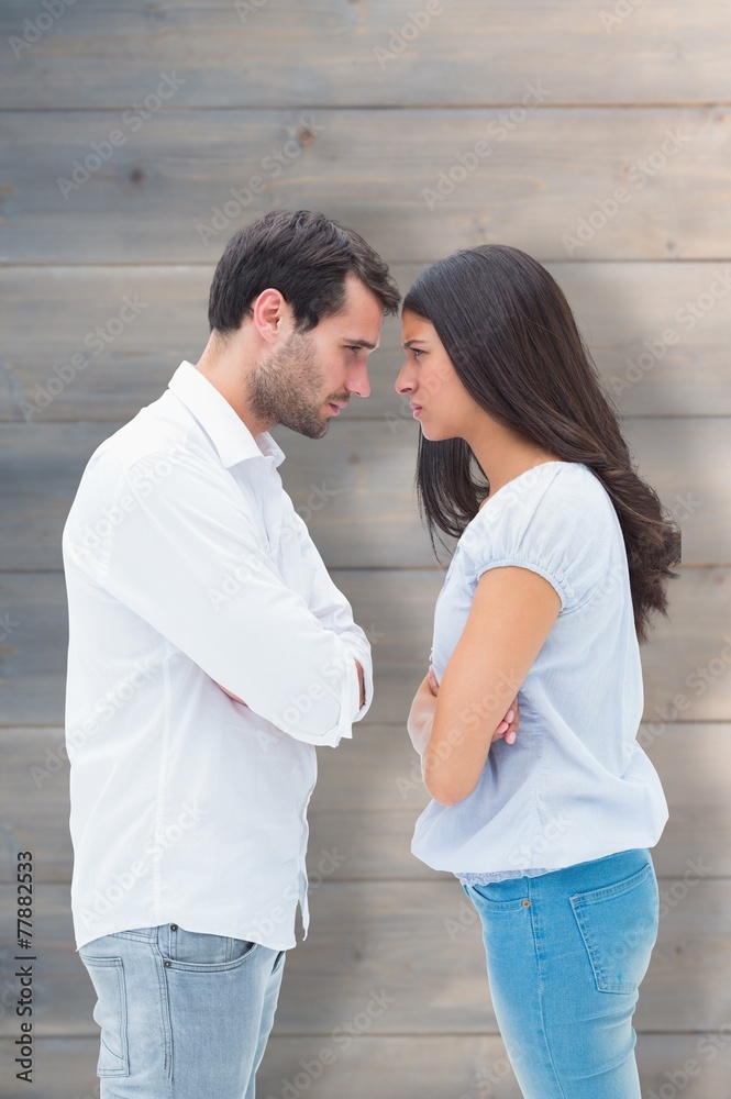 Composite image of angry couple facing off after argument Composite image of angry couple facing off after argument