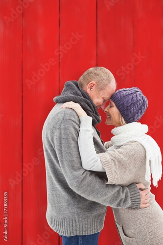 Happy mature couple in winter clothes embracing