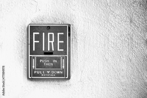 Fire alarm button on the wall black and white