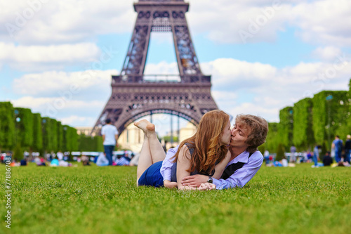 Laughing couple lying on the grass in Paris © Ekaterina Pokrovsky