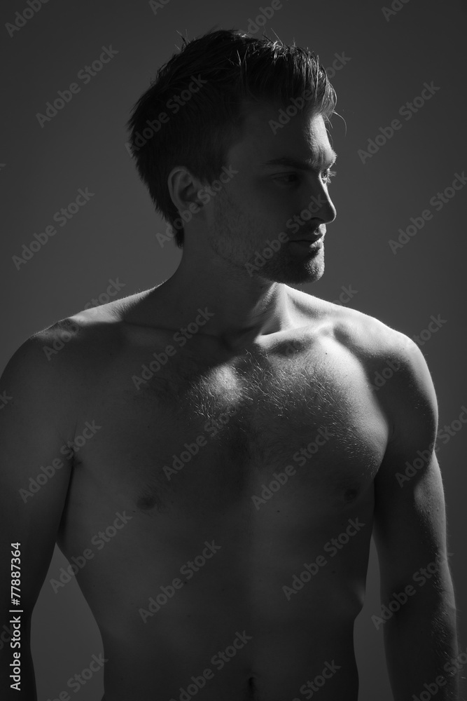 Strong athletic man on dark background Strong athletic man on dark background