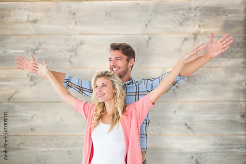 Attractive young couple standing with hands out