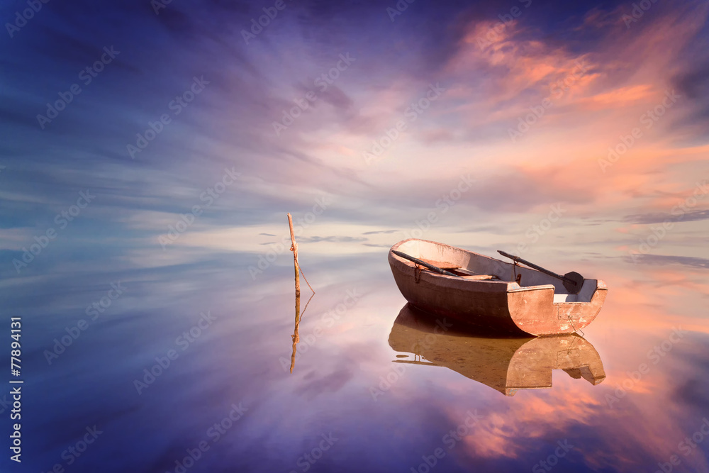Lonely boat and amazing sunset at the sea - obrazy, fototapety, plakaty 