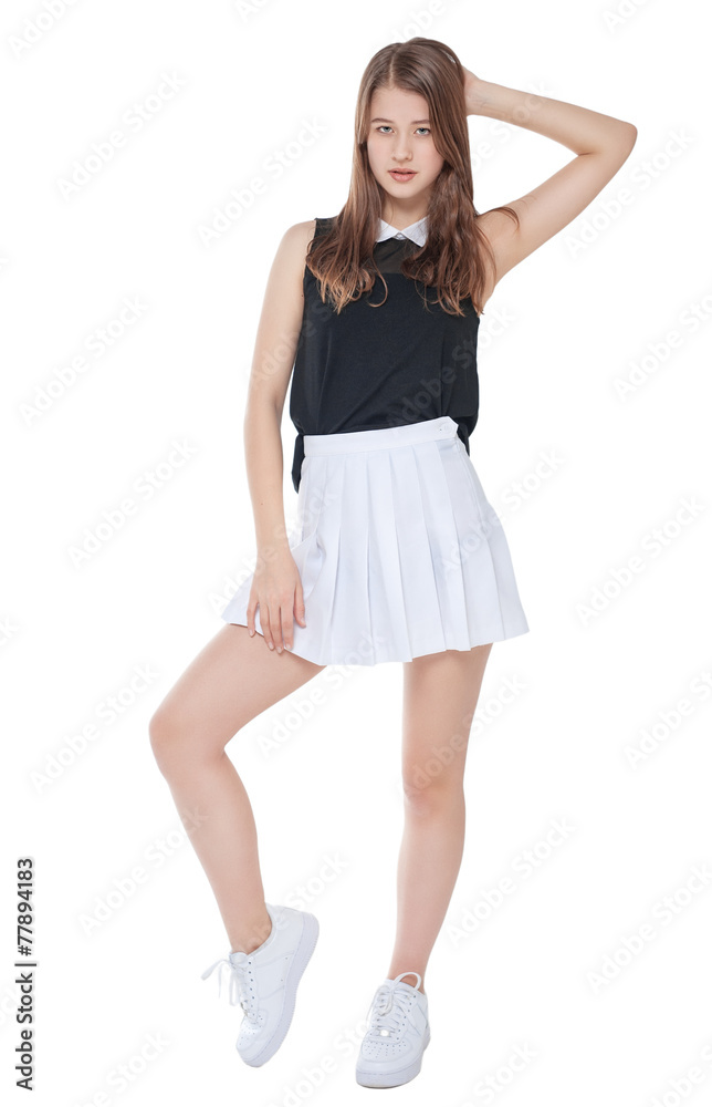 Young fashion girl in white skirt posing isolated Young fashion girl in white skirt posing isolated