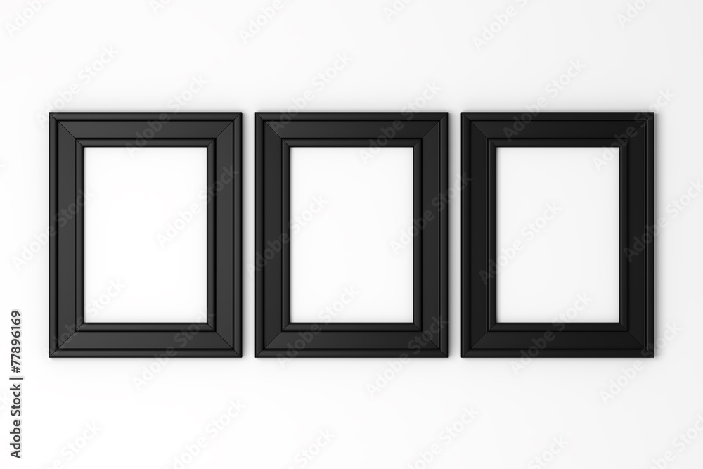 three blank black photo frames on white wall three blank black photo frames on white wall