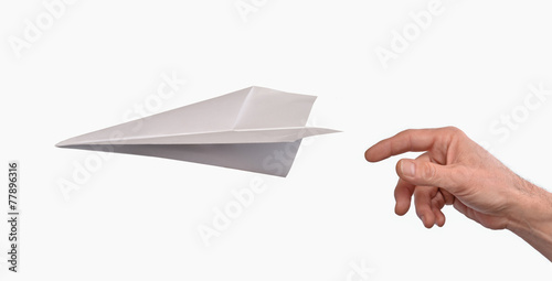 Mano lanzando un avion de papel. photo