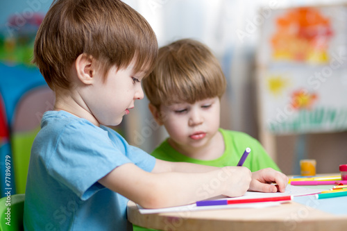 children painting in nursery at home photo