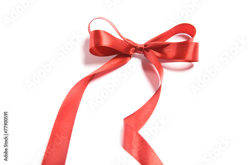 Shiny red satin ribbon and bow on white background