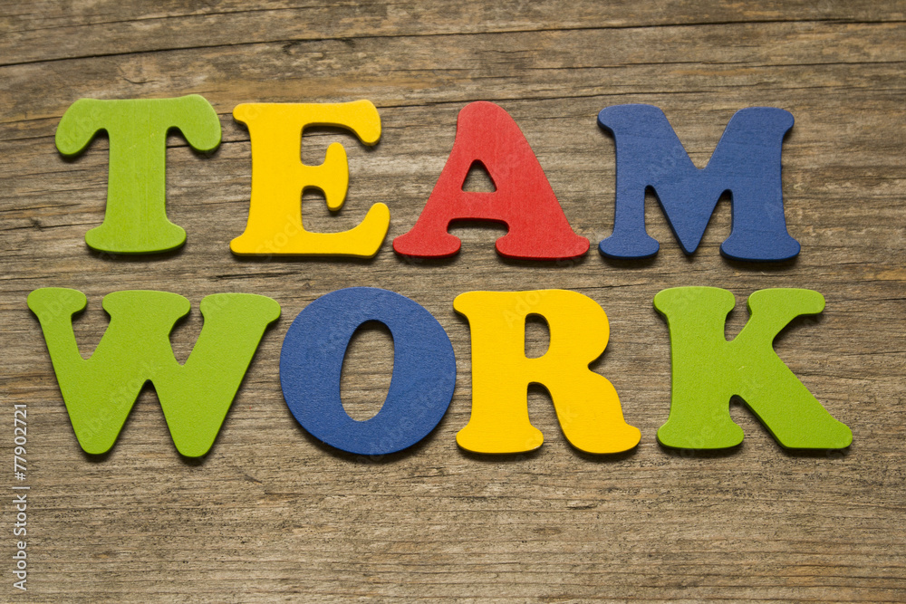 Fototapeta premium word Teamwork on a wooden background