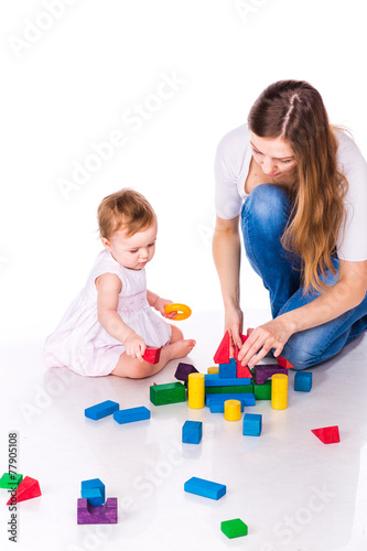 Beautiful baby with mother building with cubes