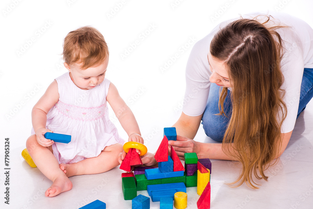 Beautiful baby with mother building with cubes Beautiful baby with mother building with cubes