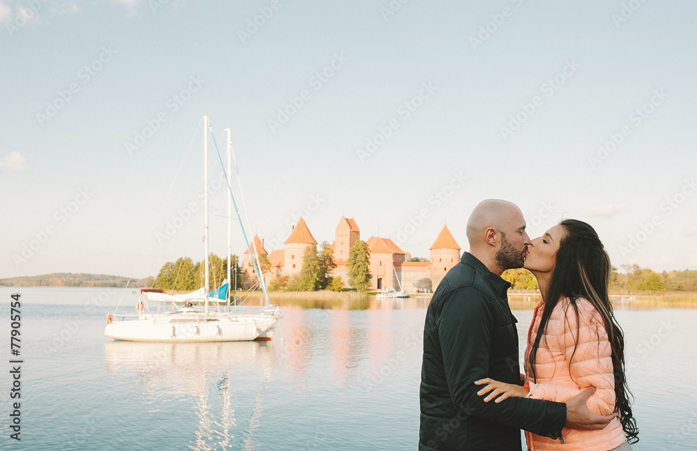 Young couple kissing at seaside on vacation in Europe