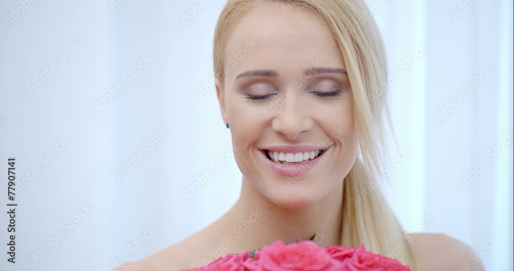 Smiling Blond Woman Smelling Pink Roses Smiling Blond Woman Smelling Pink Roses