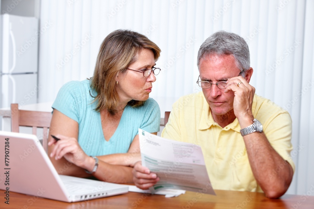 Senior couple at home with computer. Senior couple at home with computer.