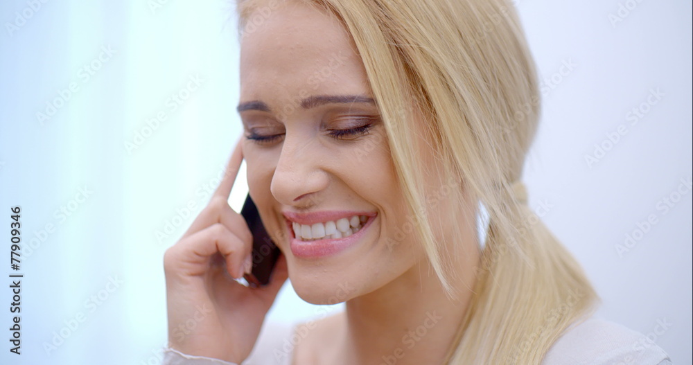 Pretty blond woman talking on her mobile Pretty blond woman talking on her mobile