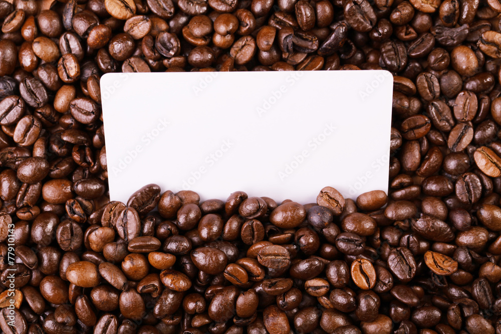 Against the backdrop of coffee beans is a business card Against the backdrop of coffee beans is a business card