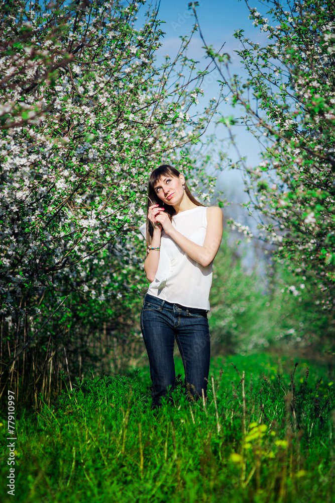 Beautiful woman on the garden with blossom apple trees Beautiful woman on the garden with blossom apple trees