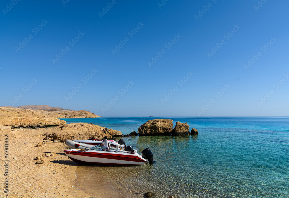 Sunny sand beach and stones on island Tiran in Egyp Sunny sand beach and stones on island Tiran in Egyp