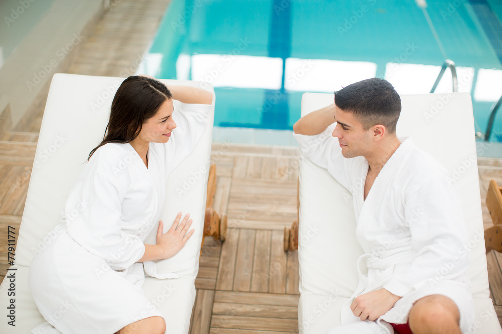 Fototapeta premium Young couple relaxing by the pool