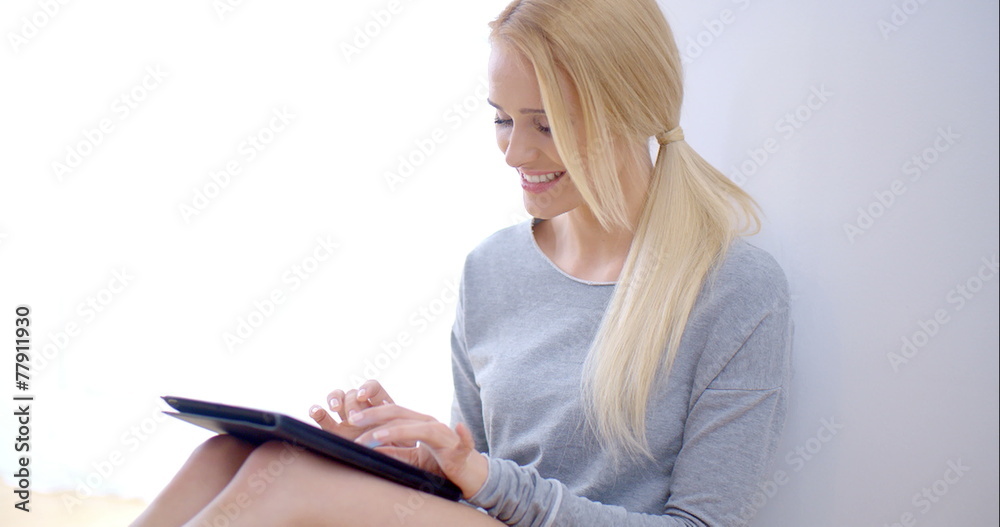 Happy Young Woman Busy with Tablet Computer
