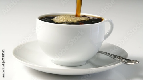 Coffee pouring into a cup and overflowing