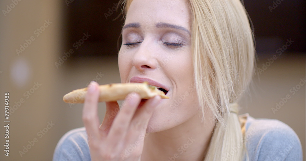 Attractive woman enjoying a slice of pizza Attractive woman enjoying a slice of pizza