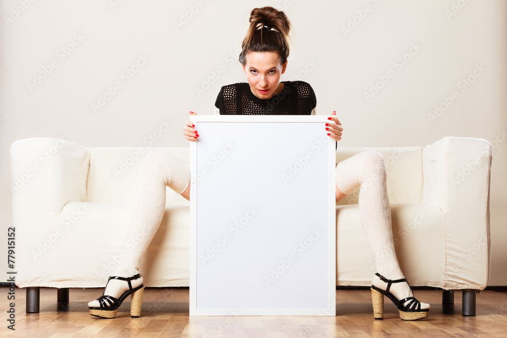 woman on sofa holding blank presentation board. woman on sofa holding blank presentation board.