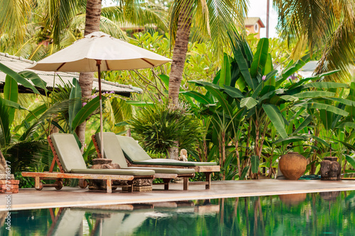 Luxurious swimming pool in a tropical garden, Thailand.