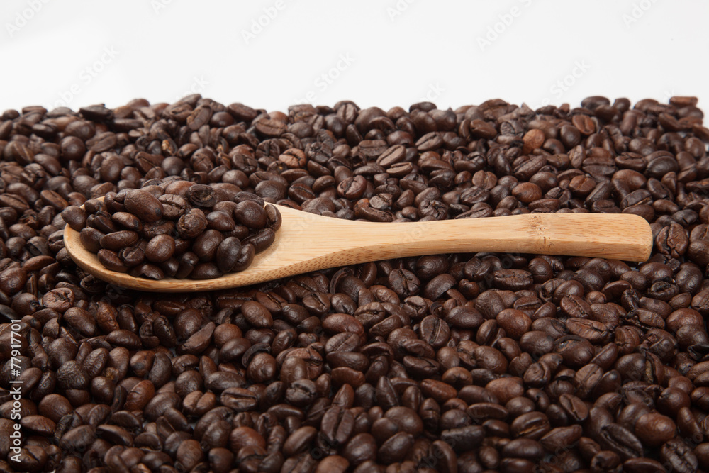 Fototapeta premium Roasted coffee beans with wooden spoon