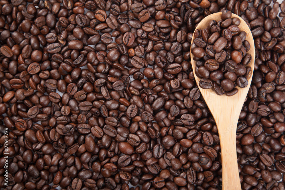 Fototapeta premium Roasted coffee beans with wooden spoon