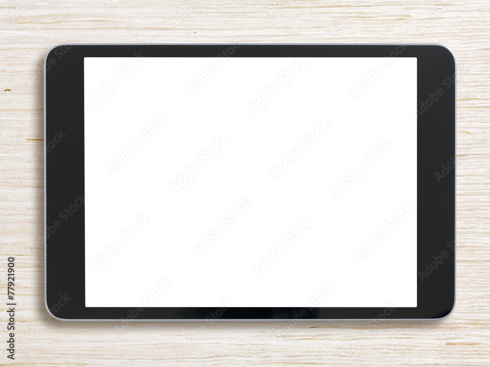 Black tablet pc or ipad on bleached wood background Black tablet pc or ipad on bleached wood background