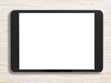 Black tablet pc or ipad on bleached wood background