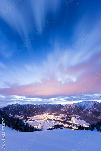 view to lights of valley from mountain at winter night