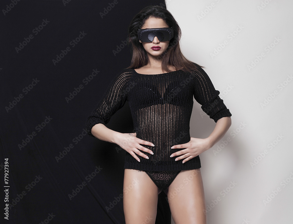 Woman with hands on her hips wearing ski sunglasses Woman with hands on her hips wearing ski sunglasses