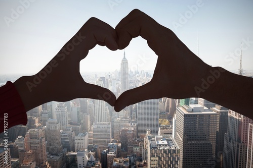 Canvas Print Composite image of couple making heart shape with hands
