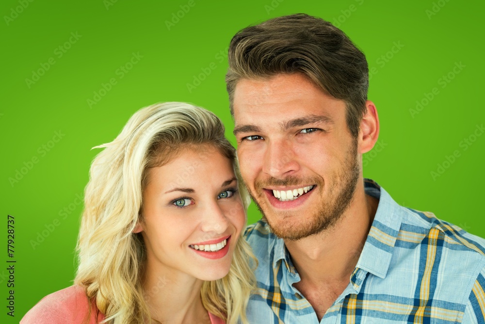 Composite image of attractive young couple smiling at camera Composite image of attractive young couple smiling at camera