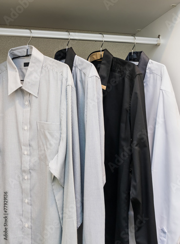 row of shirts hanging on coat hanger © worldwide_stock