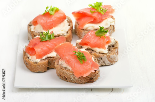 Sandwiches with salmon on white plate