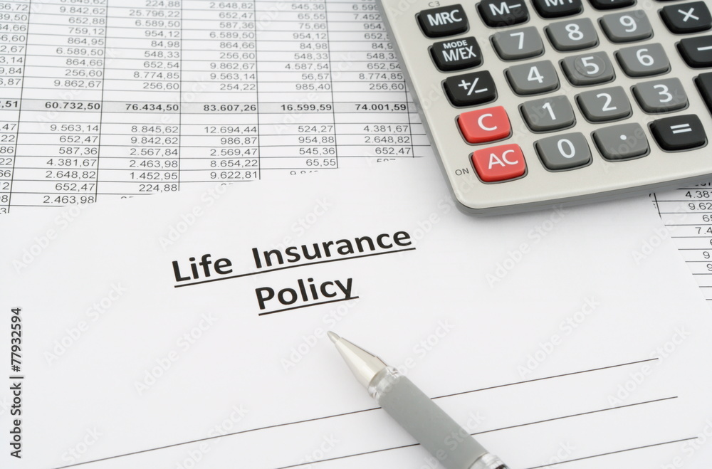 life insurance policy with numbers, calculator and pen life insurance policy with numbers, calculator and pen
