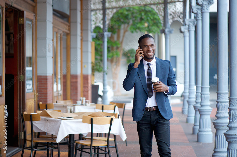 Friendly businessman walking and talking on mobile phone Friendly businessman walking and talking on mobile phone