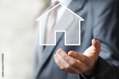 Man with touchscreen house icon sign