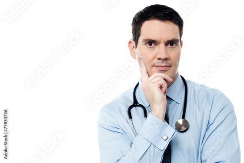 Pensive physician looking at camera
